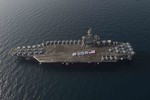 File - Sailors spell out #USA with the American flag on the flight deck of the aircraft carrier USS Theodore Roosevelt in honor of the nation's upcoming Independence Day weekend, Arabian Gulf, 28 June, 2015.