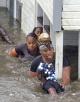 Katrina survivors make their way out of flooded buildings