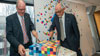 Peter Dawkins and Chancellor George Pappas cut the centenary cake