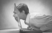 Image of man's face protruding through monitor screen