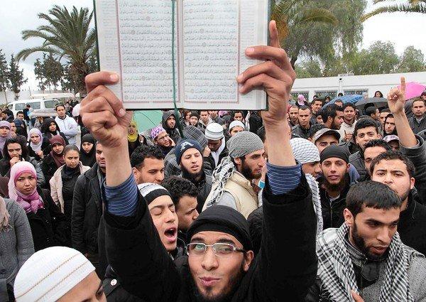 An ultraconservative Muslim holds a Koran during a protest at Manouba University in Tunis after clashes between Salafi and leftist students.