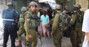 Settlers and soldiers block streets in the souq - restricting Palestinian movement