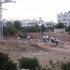 Settlers coming from the illegal settlement of Kiryat Arba onto Palestinian land for prayers