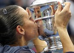 Flavia Pennetta, of Italy, kisses the championship trophy after beating Roberta Vinci, of Italy, in the women's championship match of the U.S. Open tennis tournament, Saturday, Sept. 12, 2015, in New York. (AP Photo/Julio Cortez)