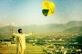 An Afghan man launches a kite from a ridge overlooking Kabul, Afghanistan.