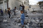 Boys play amid the rubble of a house destroyed by a Saudi-led airstrike in Sanaa, Yemen, Tuesday, Sept. 8, 2015.