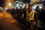 A police officer stands in the street to direct traffic as people stand in a line for public transportation after an earthquake in Santiago, Chile, Wednesday, Sept. 16, 2015. A powerful magnitude-8.3 earthquake hit off Chile's northern coast Wednesday night.