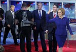 Republican presidential candidate, businesswoman Carly Fiorina, right, leads fellow candidates Scott Walker, second from right, Jeb Bush, center, and Donald Trump as they take the stage prior to the CNN Republican presidential debate at the Ronald Reagan Presidential Library and Museum on Wednesday, Sept. 16, 2015, in Simi Valley, California.