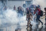 Hungarian police use tear gas at the "Horgos 2" border crossing into Hungary, near Horgos, Serbia, Wednesday, Sept. 16, 2015.