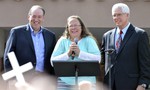 Rowan County Clerk Kim Davis, center with Republican presidential candidate Mike Huckabee, left, and attorney Mat Staver, right, founder of the Liberty Counsel, the Christian law firm representing Davis, at her side, greets the crowd after being released from the Carter County Detention Center, Tuesday, Sept. 8, 2015, in Grayson, Ky.