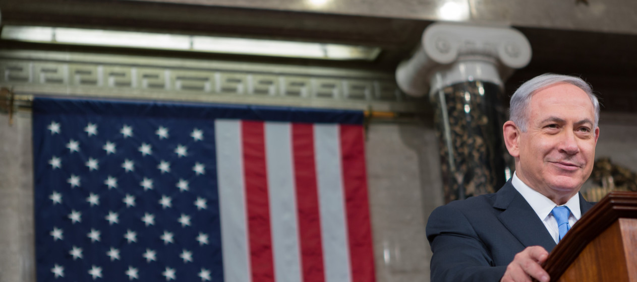 Israeli Prime Minister Benjamin Netanyahu stands at a podium in front of an American flag as he speaks to Congress on March 3, 2015. (Flickr / Speaker John Boehner / Caleb Smith)