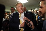 A reference to New England Patriots quarterback Tom Brady is seen on the notes of Republican presidential candidate Donald Trump as he tucks his papers into his jacket as he arrives at a town hall event Thursday, Sept. 17, 2015, in Rochester, N.H.