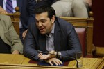 Greece's Prime Minister Alexis Tsipras laughs during a parliament meeting in Athens, Saturday, July 11, 2015. Greek lawmakers have approved a government motion seeking authorization for reform proposals as a basis for negotiations for a third bailout in talks with international creditors this weekend.