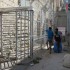 Palestinian children forced to wait at a checkpoint for soldiers to allow them to pass