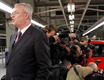 File - The CEO of Volkswagen Martin Winterkorn stands to the side as photographers shoot the new Audi A1 during the launch of production of the first Audi A1 in Brussels, Tuesday, May 11, 2010.