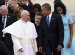 Pope Francis talks with President Barack Obama, accompanied by first lady Michelle Obama, after arriving at Andrews Air Force Base in Md., Tuesday, Sept. 22, 2015.