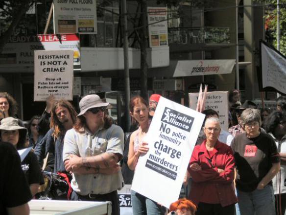 Supporters with placards outside the Qld Travel Centre