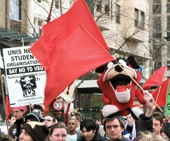 Large soft toy tiger held aloft amongst red flags