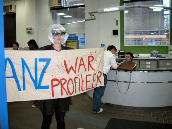 Protester holds banner - ANZ War Profiteer