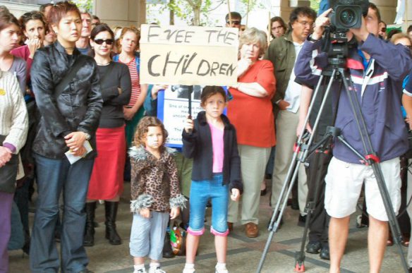 Children at front with placards