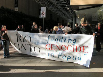 Banner - Rio Tinto - funding Genocide in Papua