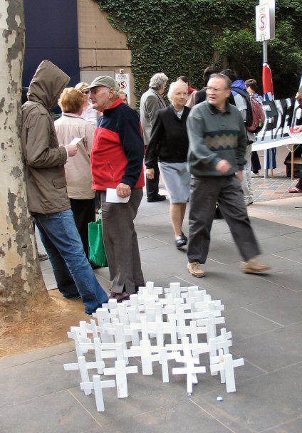 Cluster of white crosses on footpath