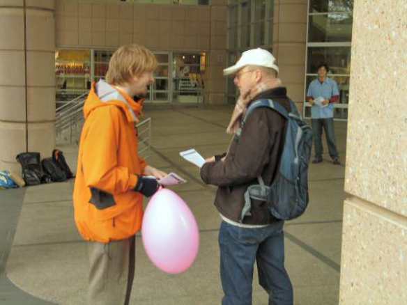 Protester handing leaflet to office worker