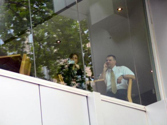 ASIO/police agents with video camera watch the protest from window on second floor