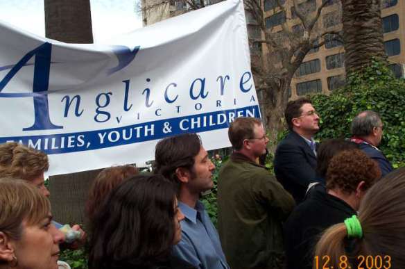 Anglicare representatives with banner