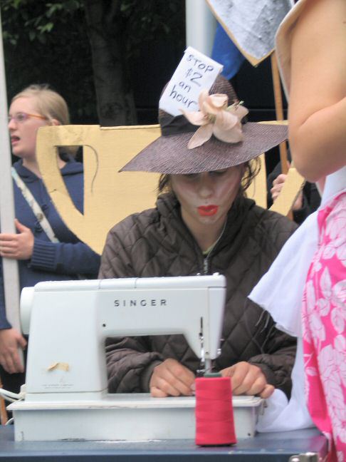 Closeup of machinist - ticket in hat 'Stop $2 an hour'