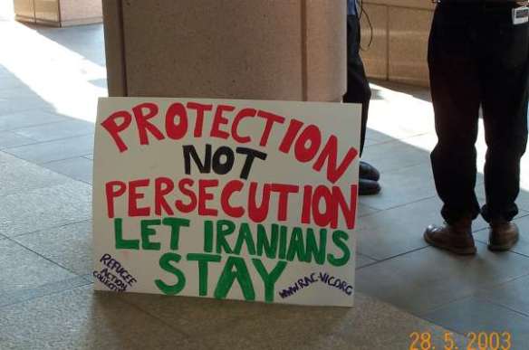 Placard: Let Iranians Stay...