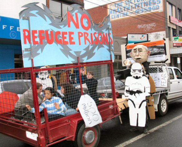 Wire cage with children, towed by truck