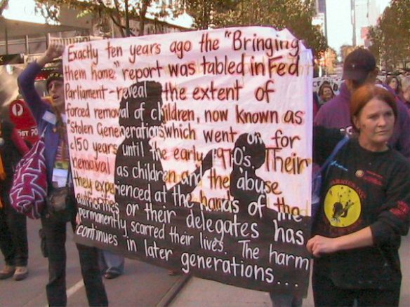 Marchers hold banner with extract from Declaration