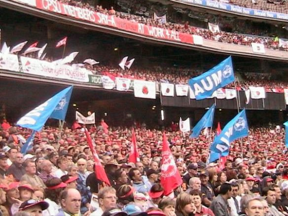 MUA banners waving over crowd in stands