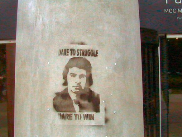 Stencil on pillar - Dare to Struggle, Dare to Win