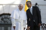 President Barack Obama leans over to talk to Pope Francis during a state arrival ceremony on the South Lawn of the White House in Washington, Wednesday, Sept. 23, 2015.