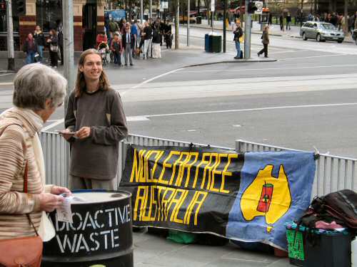 Banner and drum marked 'radioactive waste'