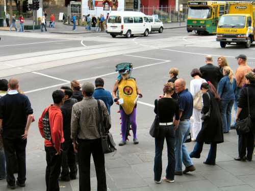 Activist in costume as radioactive mutant goanna