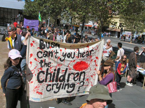 Children with banner - Bush, can't you hear the children crying