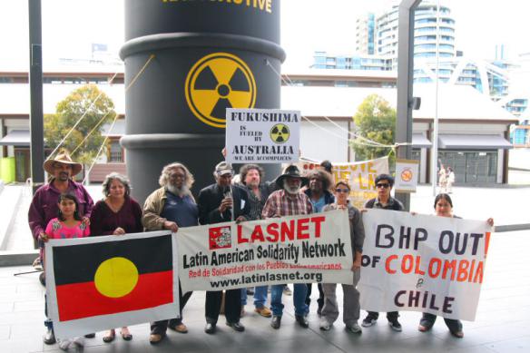 Elders and international representatives with flags and banners before barrel