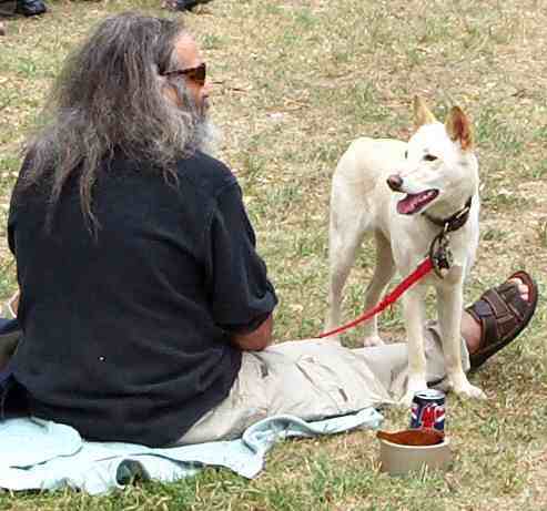 Man sitting on ground with dog