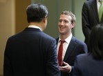 Chinese President Xi Jinping, left, talks with Facebook Chief Executive Mark Zuckerberg, right, during a gathering of CEOs and other executives at Microsoft's main campus in Redmond, Wash., Wednesday, Sept. 23, 2015.