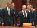 Russian President Vladimir Putin, right, passes by US President Barack Obama at the Asia-Pacific Economic Cooperation (APEC) Summit, Tuesday, Nov. 11, 2014 in Beijing.