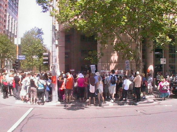 Protester gathered at corner outside Casselden Place