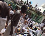 Muslim pilgrims gather around the victims of a stampede in Mina, Saudi Arabia during the annual hajj pilgrimage on Thursday, Sept. 24, 2015.