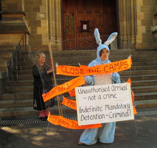 "Bunny" in wire netting with placards opposing mandatory detention etc