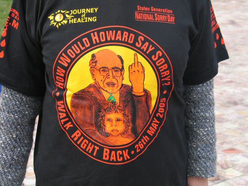 Back of T-shirt  with image of John Howard giving the finger  'How would Howard say Sorry?'