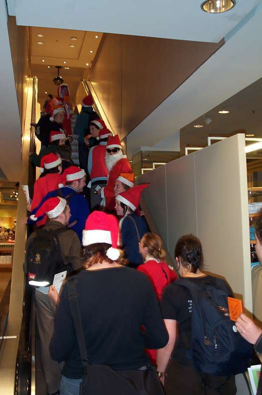 Santa's helpers going up escalator