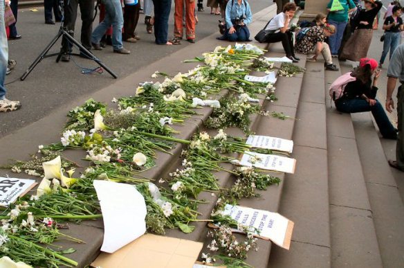 White flowers laid on the steps of Parliament House