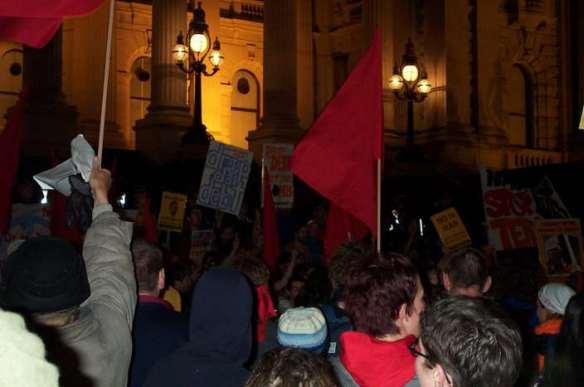 Red flags and placards outside Parliament House